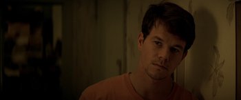 Movie still from “The Yards” (2000), directed by James Gray – A person wearing a t - shirt; Close Up shot, Over the shoulder angle