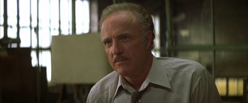 Movie still from “The Yards” (2000), directed by James Gray – An older man wearing a shirt and a tie; Close Up shot, Low angle