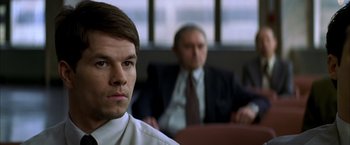 Movie still from “The Yards” (2000), directed by James Gray – A man in a suit and tie sitting in front of another man; Close Up shot, Over the shoulder angle