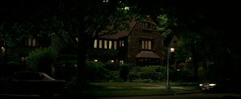 Movie still from “The Yards” (2000), directed by James Gray – A house that is lit up at night time; Extreme Wide shot, Low angle