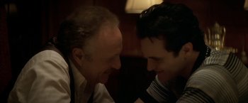 Movie still from “The Yards” (2000), directed by James Gray – Two men are smiling at each other in the dark; Close Up shot, Over the shoulder angle