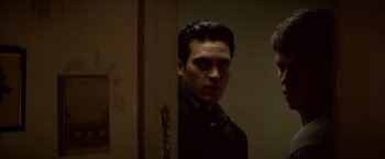 Movie still from “The Yards” (2000), directed by James Gray – A man standing in front of a door looking at the camera; Close Up shot, Over the shoulder angle