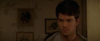 Movie still from “The Yards” (2000), directed by James Gray – A young man is sitting in a chair in a room; Close Up shot, Over the shoulder angle