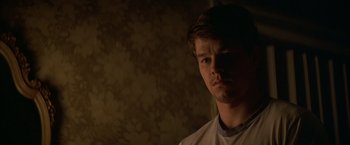Movie still from “The Yards” (2000), directed by James Gray – A young man in a white shirt is looking at the camera; Close Up shot, Low angle