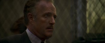 Movie still from “The Yards” (2000), directed by James Gray – A person wearing a suit and tie; Close Up shot, Low angle