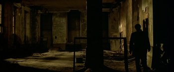 Movie still from “The Yards” (2000), directed by James Gray – A tree in an abandoned building with a light shining on it; Extreme Wide shot, Low angle