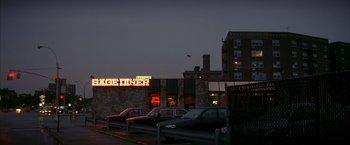 Movie still from “The Yards” (2000), directed by James Gray – A row of parked cars in front of a diner; Extreme Wide shot, High angle