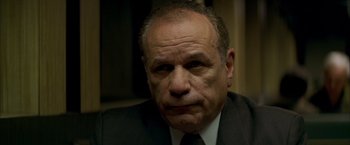 Movie still from “The Yards” (2000), directed by James Gray – An older man in a suit and tie looking sad; Close Up shot, Low angle