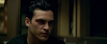 Movie still from “The Yards” (2000), directed by James Gray – A person wearing a black t - shirt; Close Up shot, Over the shoulder angle