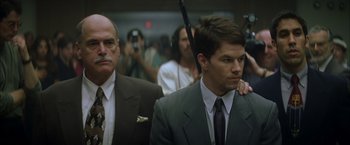 Movie still from “The Yards” (2000), directed by James Gray – A man in a suit and tie holding a gun; Close Up shot, Low angle