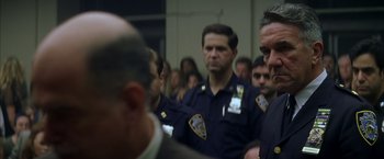 Movie still from “The Yards” (2000), directed by James Gray – A group of police officers standing next to each other in a room; Close Up shot, Over the shoulder angle