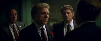 Movie still from “The Yards” (2000), directed by James Gray – A man in a suit and tie standing next to another man in a suit and tie; Close Up shot, Over the shoulder angle