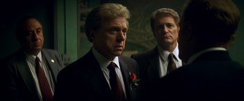 Movie still from “The Yards” (2000), directed by James Gray – A man in a suit and tie standing next to another man in a suit and tie; Close Up shot, Over the shoulder angle