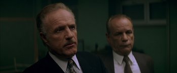 Movie still from “The Yards” (2000), directed by James Gray – A man in a suit and tie standing next to another man in a suit and tie; Close Up shot, Low angle