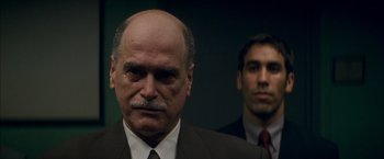 Movie still from “The Yards” (2000), directed by James Gray – A man with a beard and a mustache wearing a suit; Close Up shot, Low angle