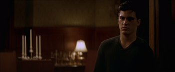 Movie still from “The Yards” (2000), directed by James Gray – A man standing in front of a lamp in a room; Close Up shot, Over the shoulder angle