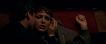 Movie still from “The Yards” (2000), directed by James Gray – A woman sitting next to a man on a couch; Close Up shot, High angle