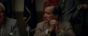 Movie still from “The Yards” (2000), directed by James Gray – A person sitting in front of a microphone; Close Up shot, Over the shoulder angle