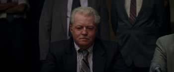 Movie still from “The Yards” (2000), directed by James Gray – An older man wearing a suit and tie; Close Up shot, Low angle