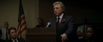 Movie still from “The Yards” (2000), directed by James Gray – A man standing at a podium speaking to a crowd; Close Up shot, Low angle