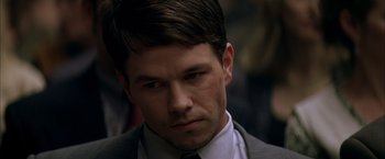 Movie still from “The Yards” (2000), directed by James Gray – A person wearing a suit and tie; Close Up shot, Over the shoulder angle