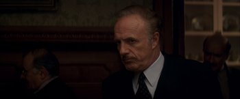 Movie still from “The Yards” (2000), directed by James Gray – An older man wearing a suit and tie; Close Up shot, Low angle