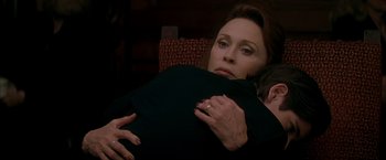 Movie still from “The Yards” (2000), directed by James Gray – A woman holding a man in her arms; Close Up shot, High angle