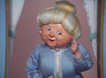 Movie still from “The Year Without a Santa Claus” (1974), directed by Jules Bass – An old lady doll with a white hair and blue dress; Close Up shot, Low angle