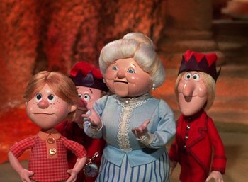 Movie still from “The Year Without a Santa Claus” (1974), directed by Jules Bass – A group of people standing next to each other; Medium shot, Low angle