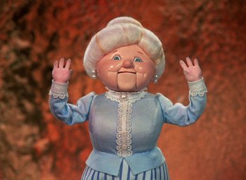 Movie still from “The Year Without a Santa Claus” (1974), directed by Jules Bass – The face of an old woman doll; Medium shot, Low angle