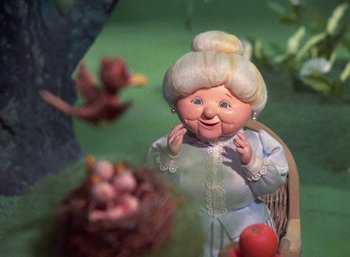 Movie still from “The Year Without a Santa Claus” (1974), directed by Jules Bass – An old woman doll is sitting in a chair; Close Up shot, Low angle