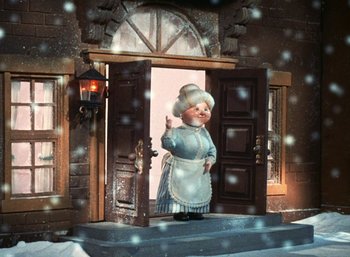 Movie still from “The Year Without a Santa Claus” (1974), directed by Jules Bass – An animated character is standing at the entrance of a house; Wide shot, Low angle