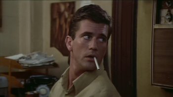 Movie still from “The Year of Living Dangerously” (1982), directed by Peter Weir – A person with a cigarette in his mouth; Close Up shot, Low angle