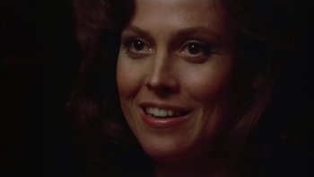 Movie still from “The Year of Living Dangerously” (1982), directed by Peter Weir – A woman smiling for the camera; Close Up shot, Low angle