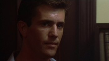 Movie still from “The Year of Living Dangerously” (1982), directed by Peter Weir – A man's face in a dark room; Close Up shot, Over the shoulder angle
