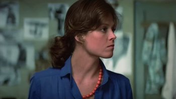 Movie still from “The Year of Living Dangerously” (1982), directed by Peter Weir – A person wearing a blue shirt; Close Up shot, Low angle