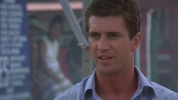 Movie still from “The Year of Living Dangerously” (1982), directed by Peter Weir – A person wearing a blue shirt; Close Up shot, Low angle