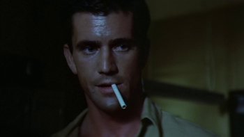 Movie still from “The Year of Living Dangerously” (1982), directed by Peter Weir – A person with a cigarette in his mouth; Close Up shot, Low angle