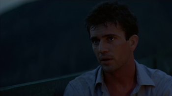 Movie still from “The Year of Living Dangerously” (1982), directed by Peter Weir – A person sitting in front of a window; Close Up shot, Low angle