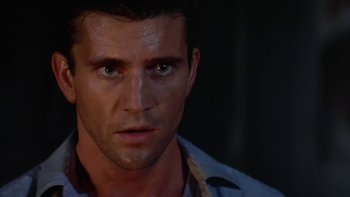 Movie still from “The Year of Living Dangerously” (1982), directed by Peter Weir – A man's face in a dark room; Close Up shot, Low angle