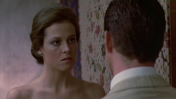 Movie still from “The Year of Living Dangerously” (1982), directed by Peter Weir – A woman looking at a man in the mirror; Close Up shot, Over the shoulder angle