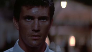 Movie still from “The Year of Living Dangerously” (1982), directed by Peter Weir – A man's face in the dark; Close Up shot, Low angle