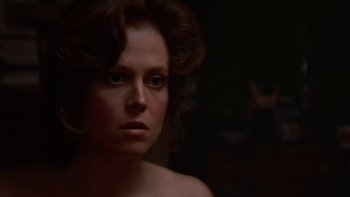 Movie still from “The Year of Living Dangerously” (1982), directed by Peter Weir – A person in a dark room; Close Up shot, Over the shoulder angle