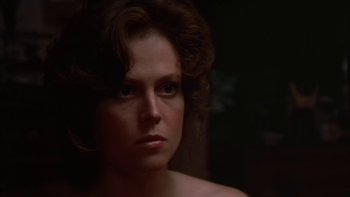 Movie still from “The Year of Living Dangerously” (1982), directed by Peter Weir – A person wearing a bra; Close Up shot, Over the shoulder angle