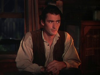 Movie still from “The Yearling” (1946), directed by Clarence Brown – A man sitting in front of a window in a room; Medium shot, High angle