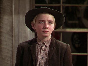 Movie still from “The Yearling” (1946), directed by Clarence Brown – A young man wearing a hat and a jacket; Close Up shot, Low angle