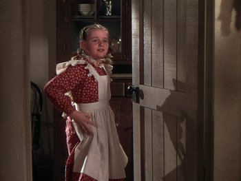 Movie still from “The Yearling” (1946), directed by Clarence Brown – A young girl dressed as a maid in a kitchen; Medium shot, Low angle