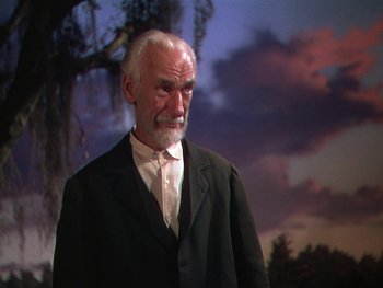 Movie still from “The Yearling” (1946), directed by Clarence Brown – An older man in a suit and white shirt; Medium shot, Low angle