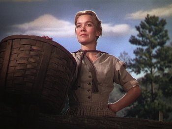 Movie still from “The Yearling” (1946), directed by Clarence Brown – A woman standing next to a basket on top of a tree; Medium shot, Low angle
