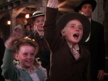 Movie still from “The Yearling” (1946), directed by Clarence Brown – A group of people standing next to each other in a room; Medium shot, Low angle